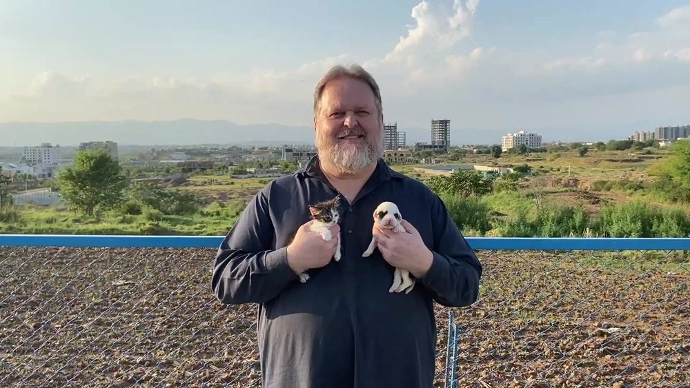 Todd Shea with two rescued puppies