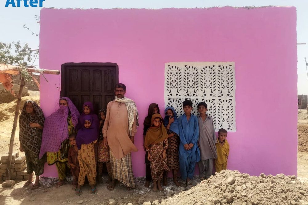 A family outside their newly built CDRS home