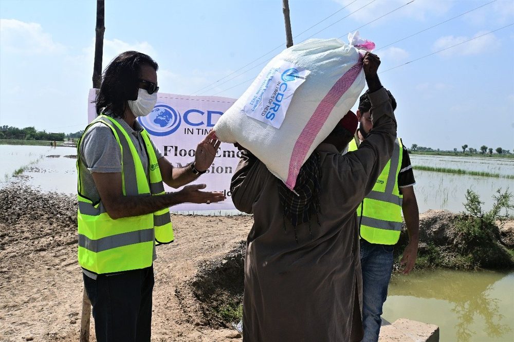 CDRS staff handing over a ration pack