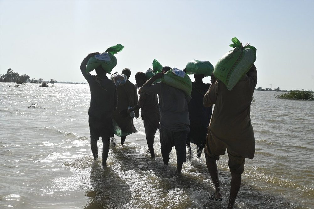 Families wading home from a CDRS flood distribution
