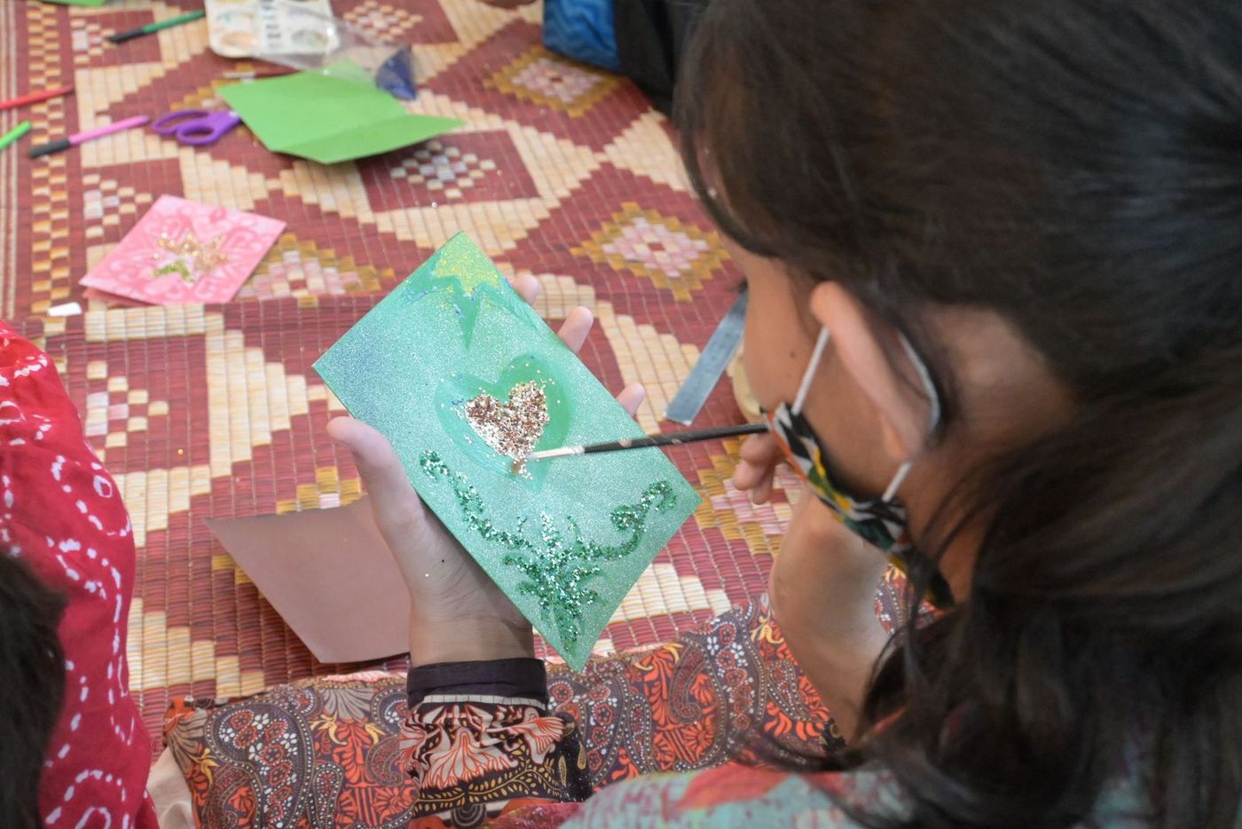 A young woman doing detailed embroidery in a CDRS skills programme