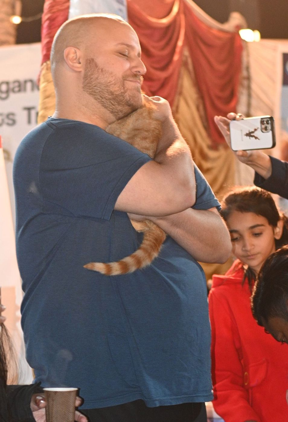 Todd Shea holding a rescued cat at a CDRS Benji Project event