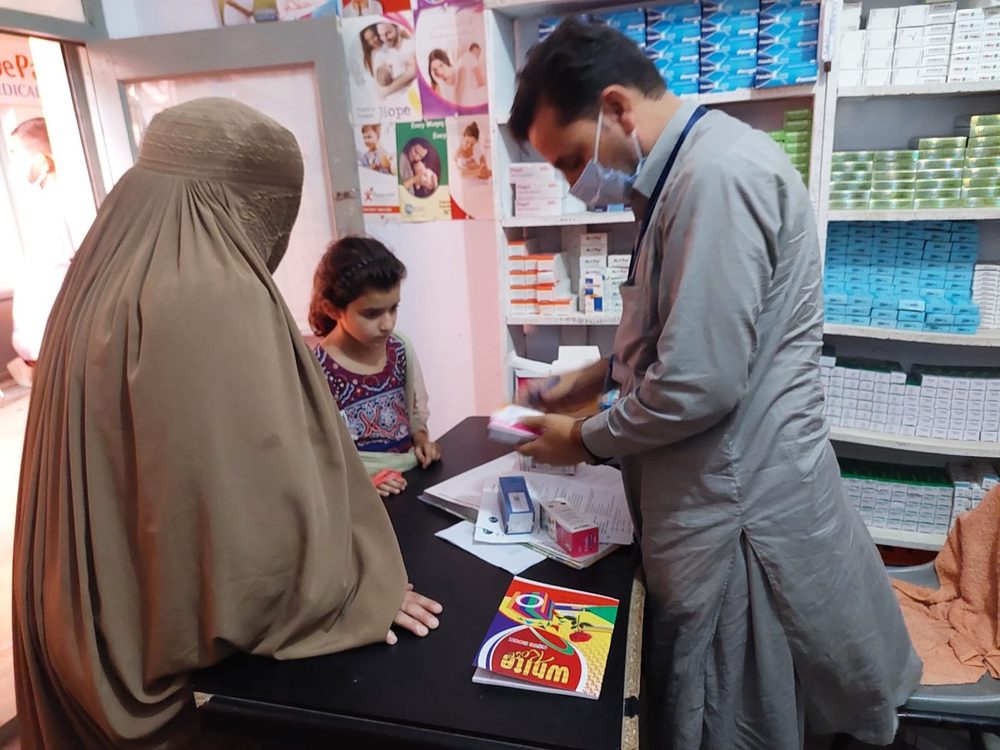 A family collecting medicines at a CDRS pharmacy