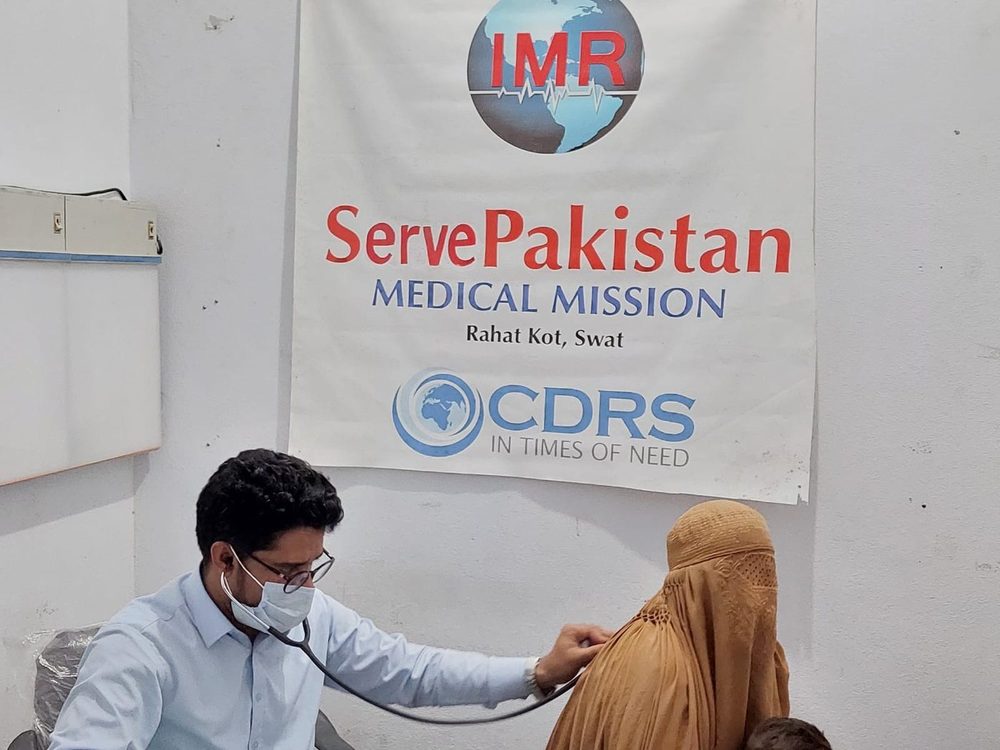 A doctor examining a patient at a CDRS medical mission in Rahat Kot, Swat