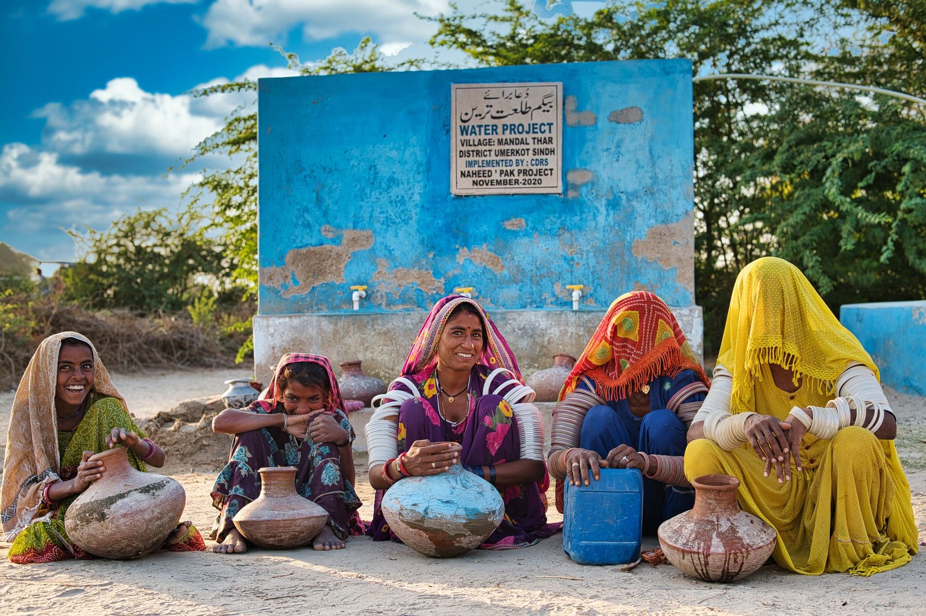 Families gathered at a CDRS village water point