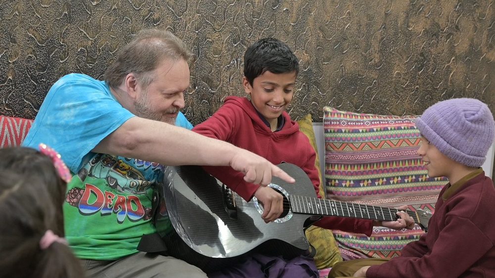 Children learning guitar in a CDRS programme