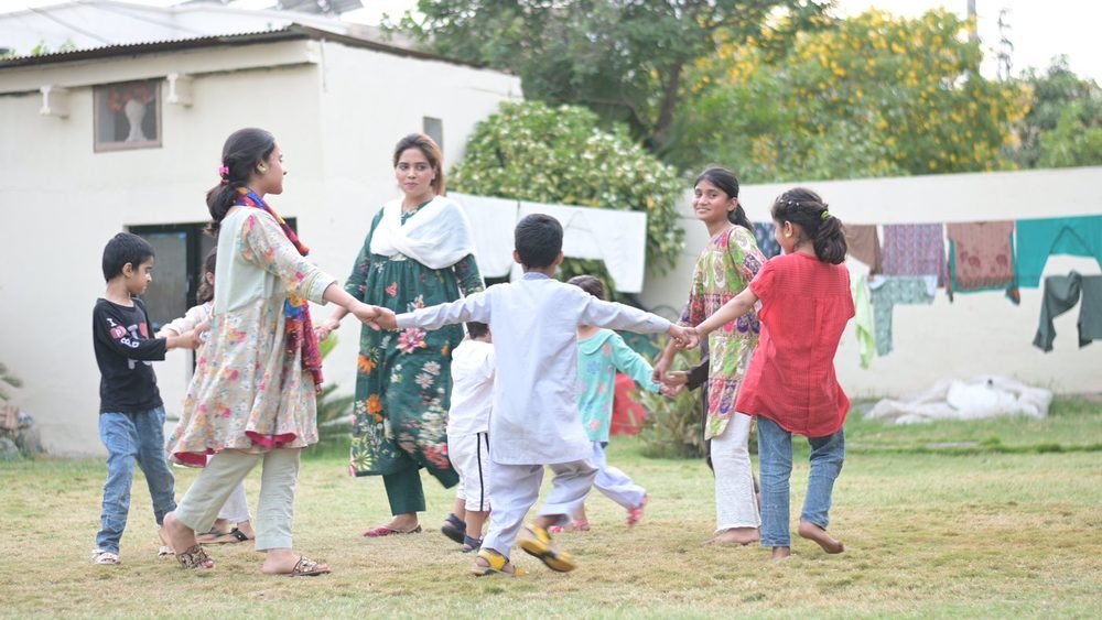Children and house mothers playing together