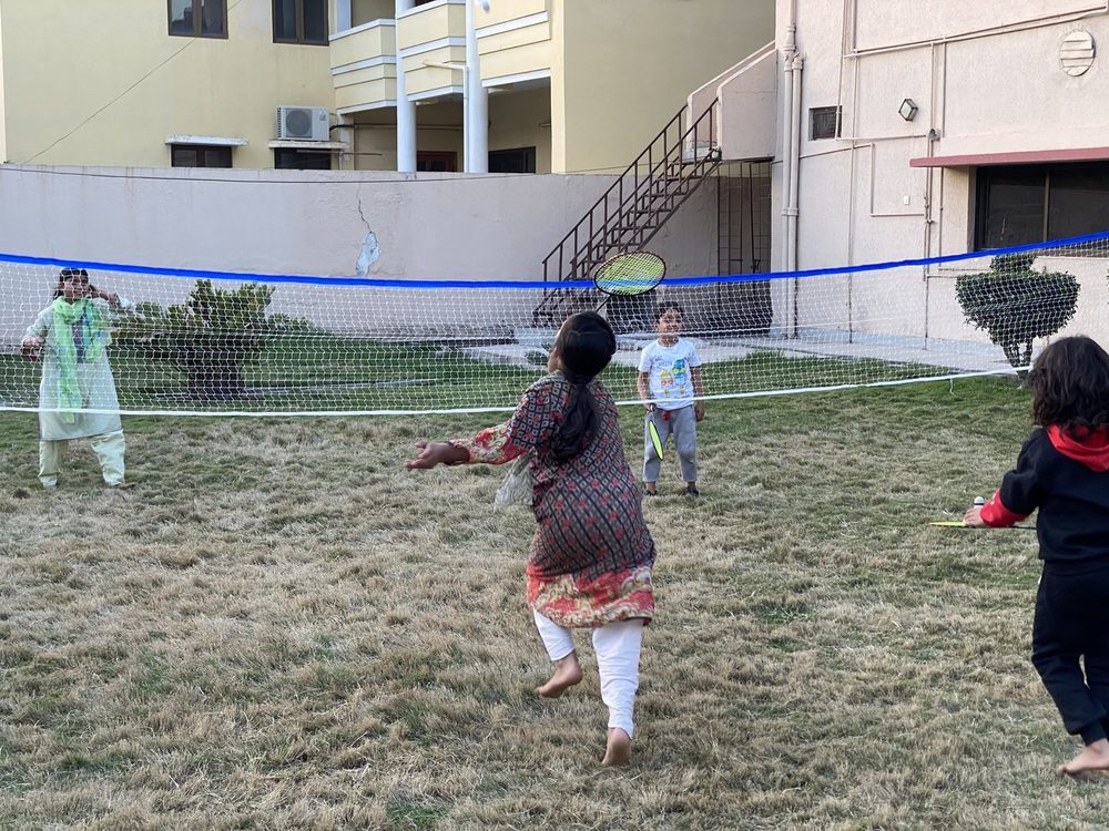 Children playing volleyball in the House of Blessings yard