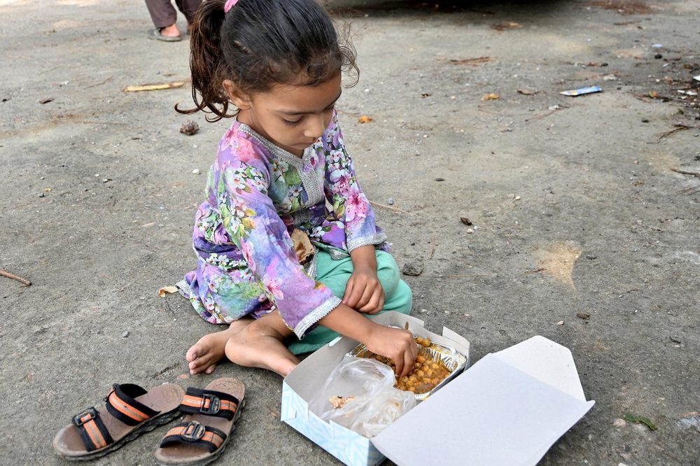 A girl eating a Mari Dastarkhwan meal