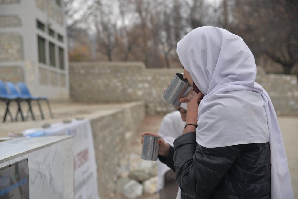 A pupil with a cup of clean water