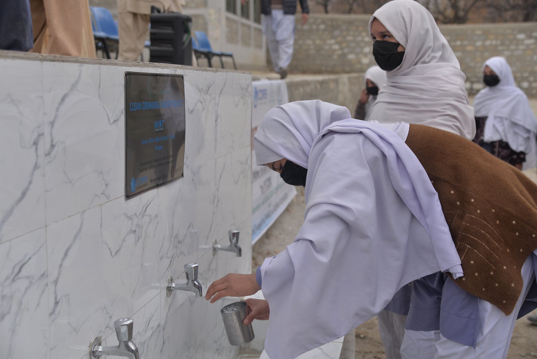 Schoolgirls at a Wipe Out Thirst drinking water point